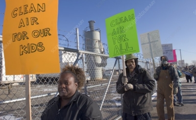 Photo of protestors outside of fenced area