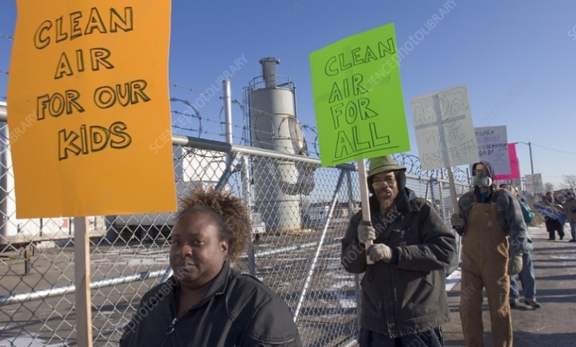 Photo of protestors outside of fenced area