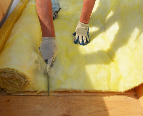 Photo of person cutting into insulation